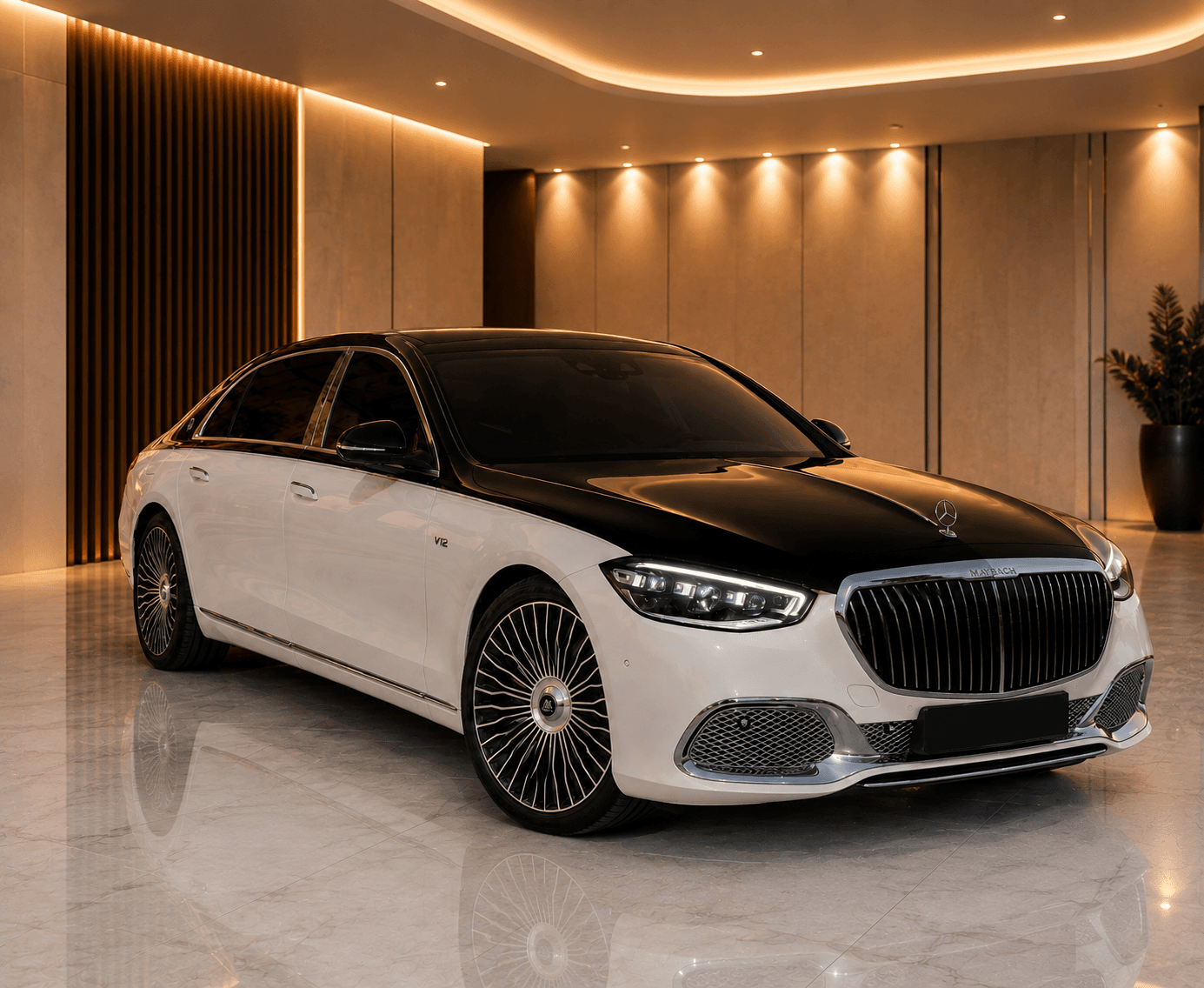 Two-tone white and black Mercedes-Maybach S-Class front three-quarter view in a marble-floored showroom