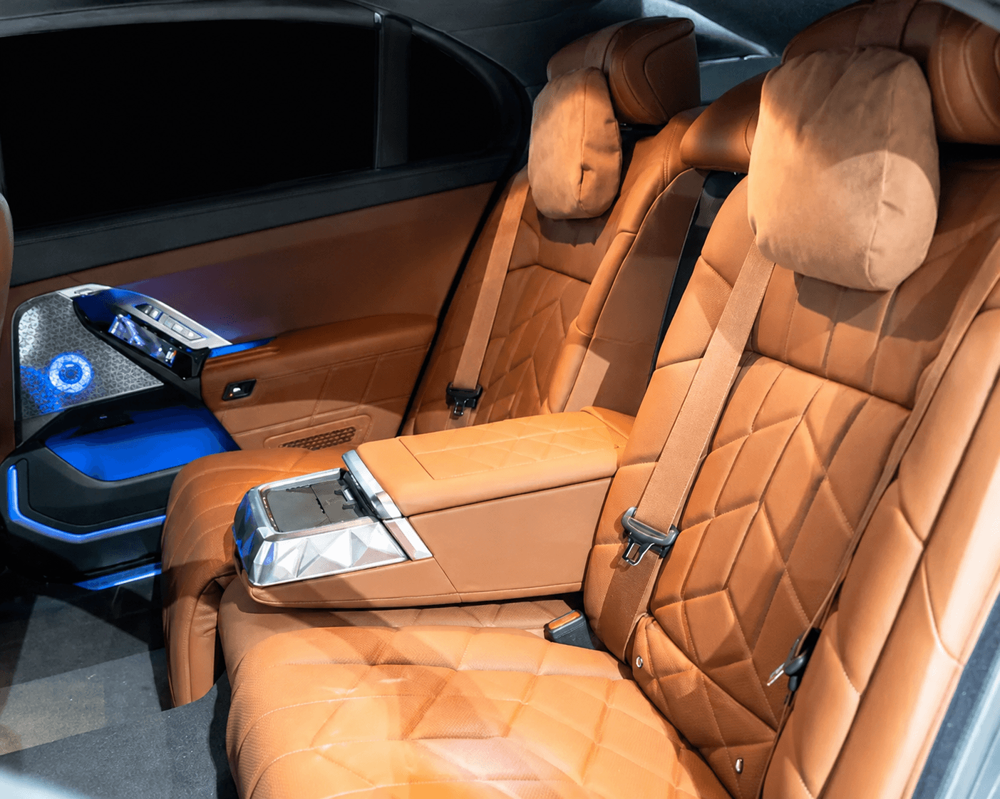 BMW 7 Series rear seats with headrest cushions and illuminated rear-door touchscreen controls