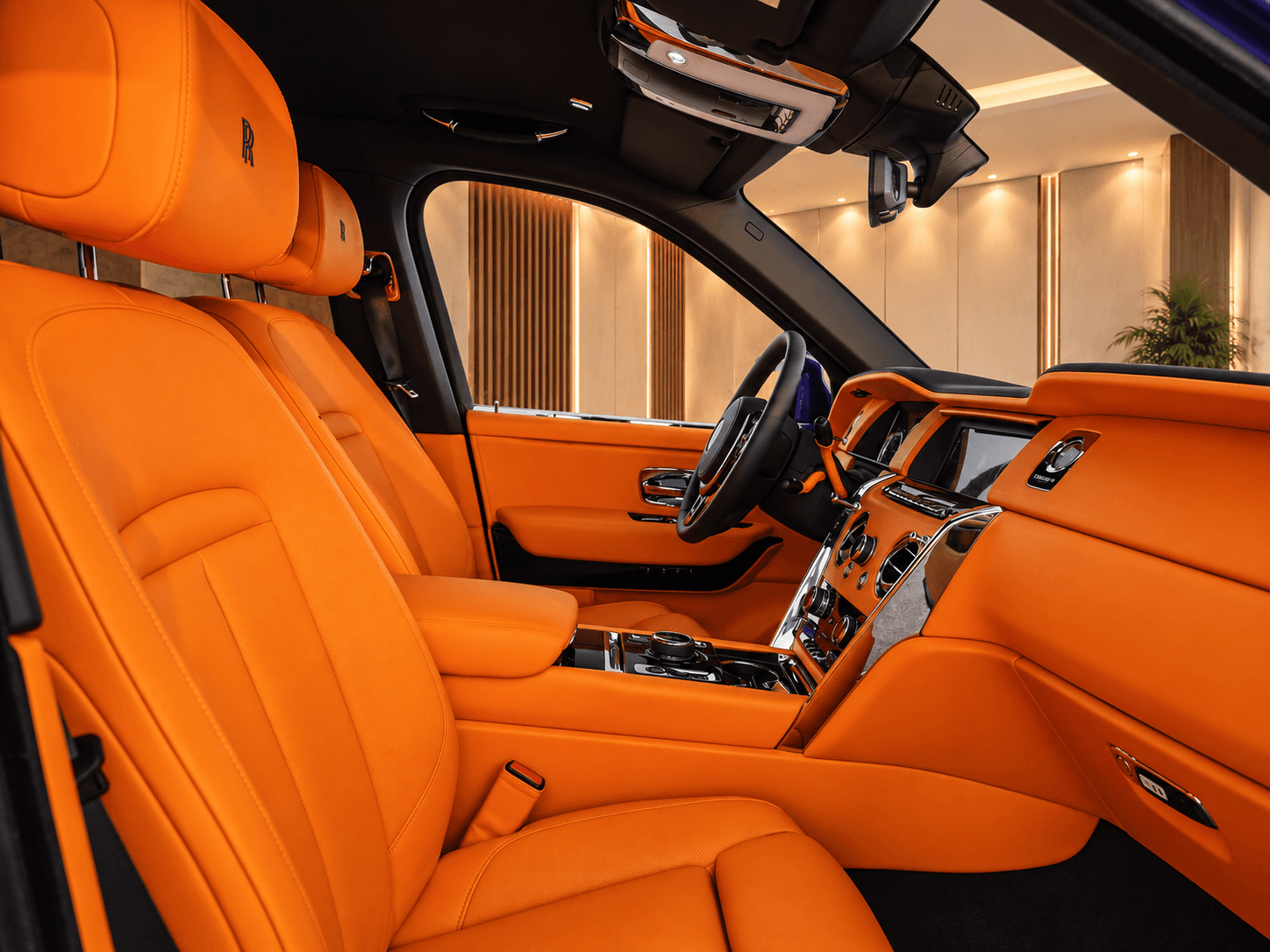 Mandarin orange leather front seats and dashboard inside the Rolls-Royce Cullinan Black Badge