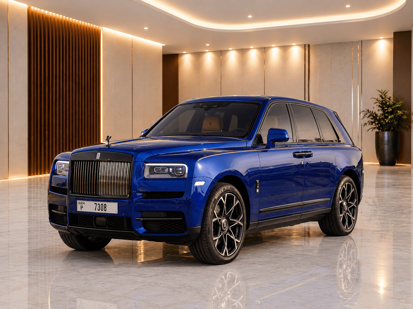 Blue Rolls-Royce Cullinan Black Badge chauffeur car, front three-quarter view in a luxury marble showroom in Dubai
