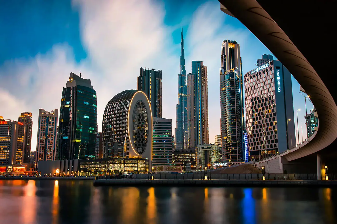 Burj Khalifa and Business Bay skyline at dusk, viewed from the Dubai Water Canal bridge