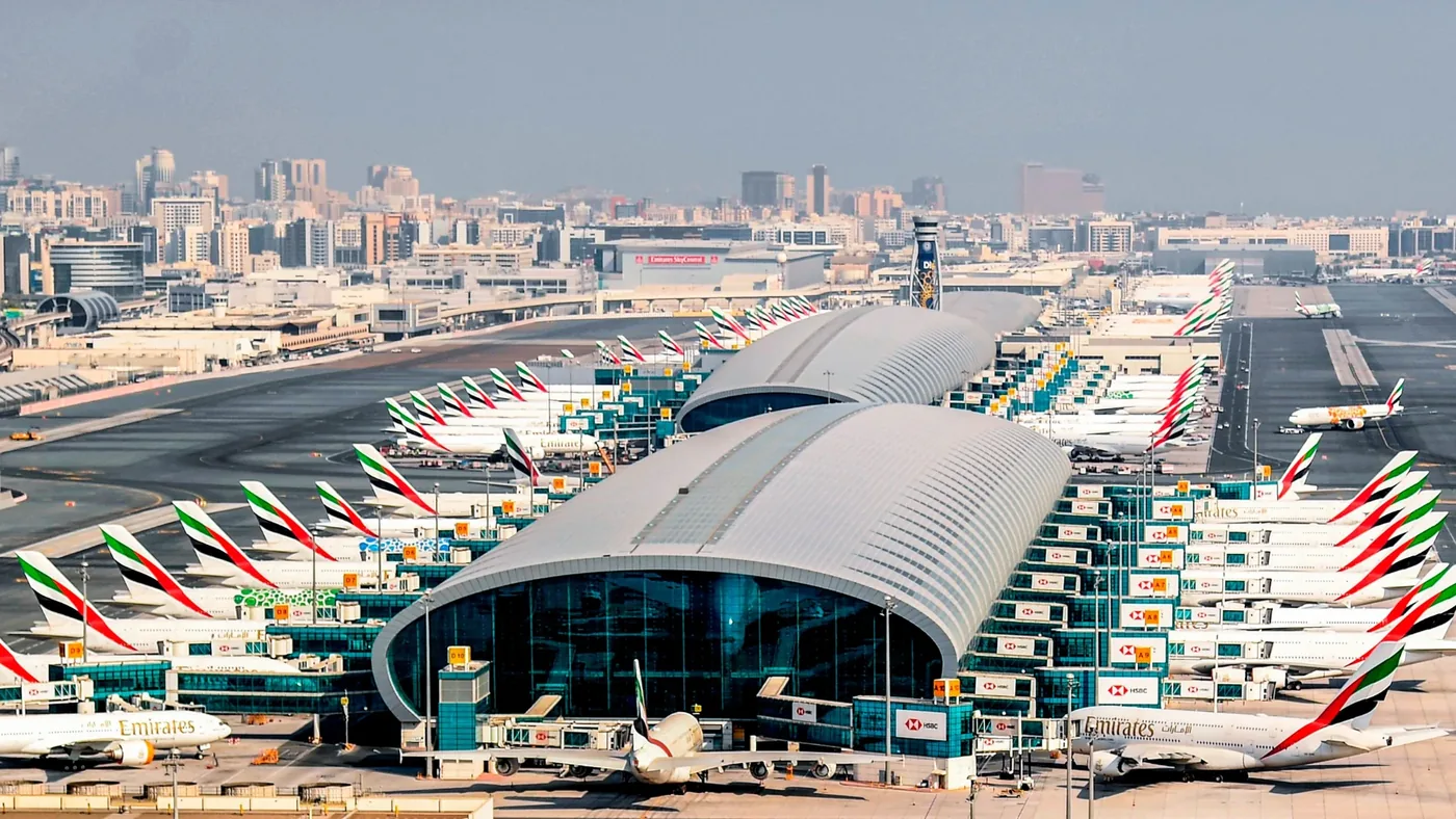 Emirates aircraft lined up at Dubai International Airport terminal